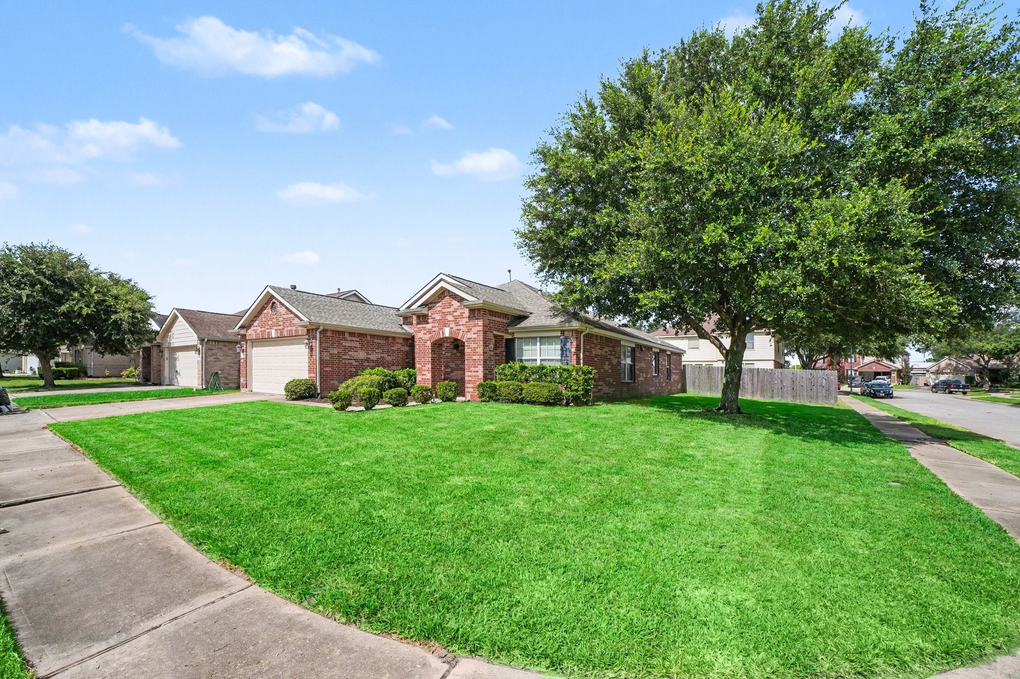 21427 Blooming Rock Lane Spring, TX 77379 - Photo 1 of 32 Charming brick home on a corner lot with a well-maintained lawn, mature tree, and a two-car garage. Located in a quiet neighborhood, offering great curb appeal.
