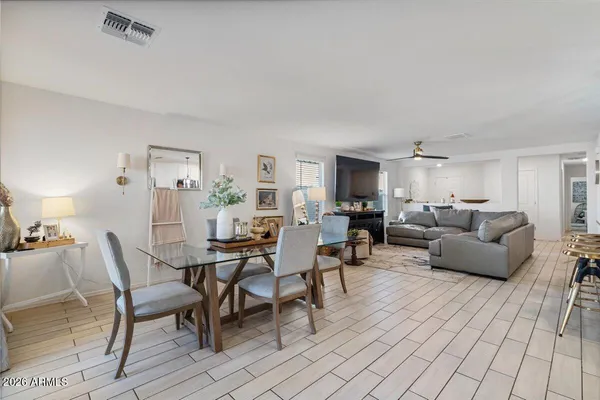 a kitchen with white cabinets stainless steel appliances and dining table
