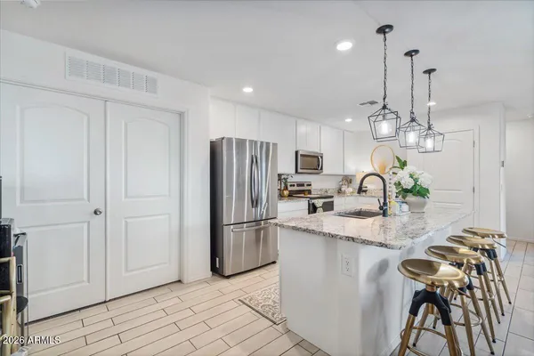 a kitchen with refrigerator and microwave