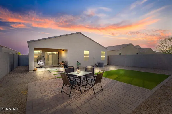 a view of a patio with a table and chairs