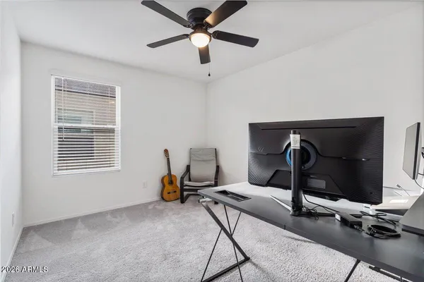 a work room with furniture and a flat screen tv