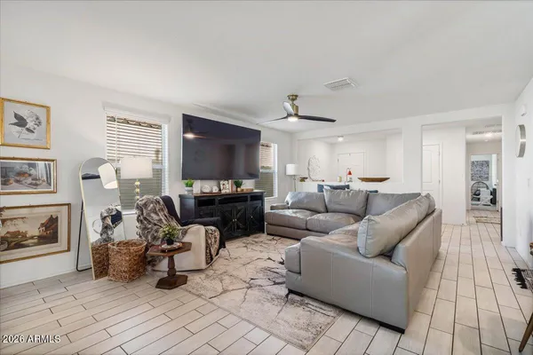 a living room with furniture kitchen and a chandelier
