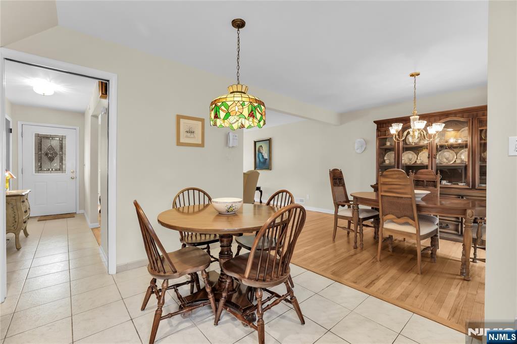 23 Ridge Court Cedar Grove, NJ 07009 - Photo 13 of 37 a view of a dining room and livingroom with furniture wooden floor a chandelier