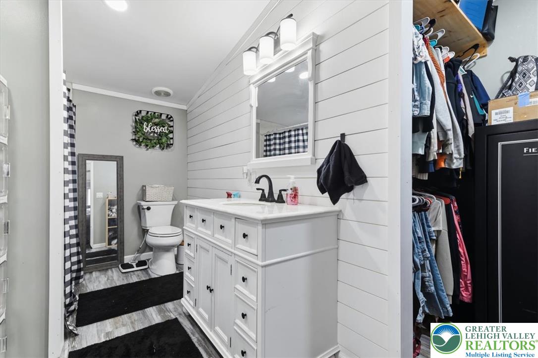634 Main Road Lehighton, PA 18235 - Photo 25 of 39 A well-appointed bathroom vanity with shiplap walls and ample storage.