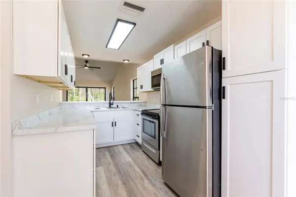 a kitchen with cabinets and stainless steel appliances