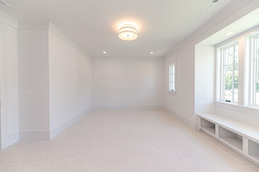 1008 Welch Lane Raleigh, NC 27614 - Photo 36 of 46 an empty room with windows and view of kitchen
