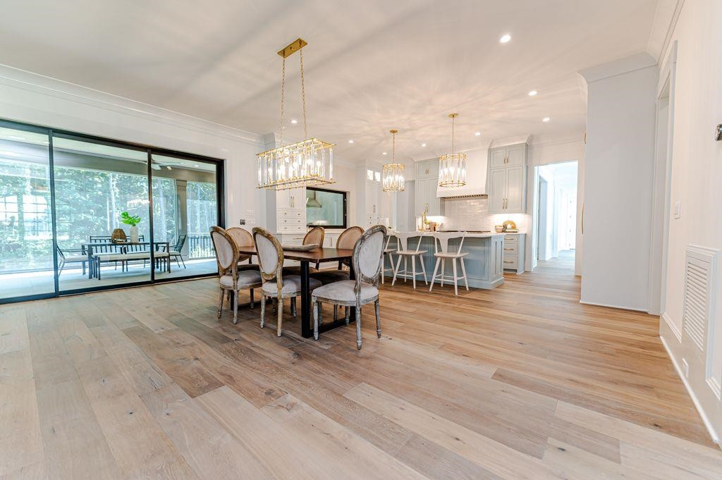 1008 Welch Lane Raleigh, NC 27614 - Photo 6 of 46 a view of a dining room and livingroom with furniture wooden floor a chandelier