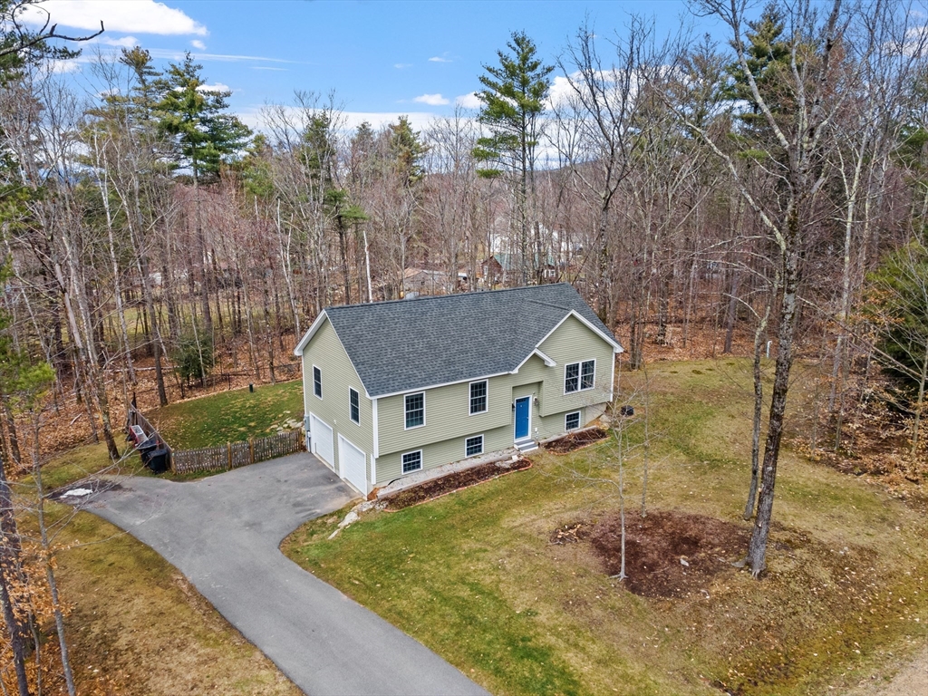 aerial view of a house with a yard