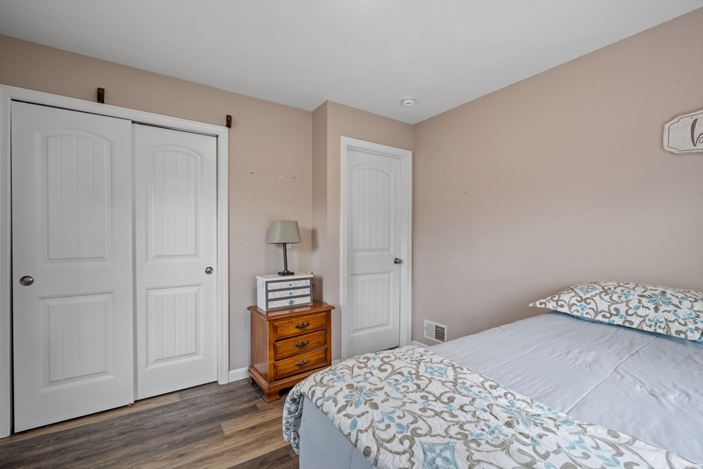3 Fieldstone Drive Deerfield, NH 03037 - Photo 15 of 28 a bedroom with a bed and wooden floor