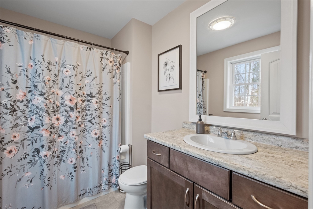 3 Fieldstone Drive Deerfield, NH 03037 - Photo 19 of 28 a bathroom with a granite countertop sink and a mirror