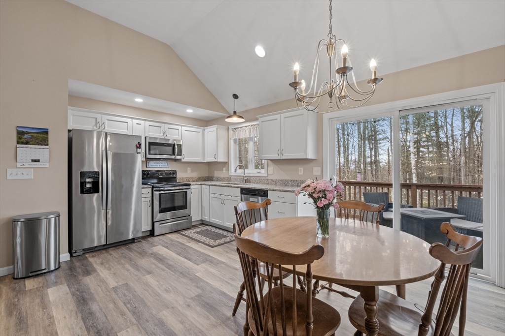 3 Fieldstone Drive Deerfield, NH 03037 - Photo 10 of 28 a kitchen with refrigerator cabinets dining table and chairs