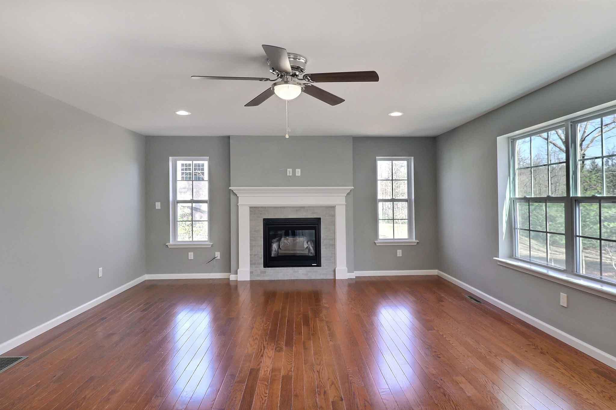 552 Long Mountain Road Effort, PA 18330 - Photo 13 of 47 an empty room with wooden floor fireplace and windows