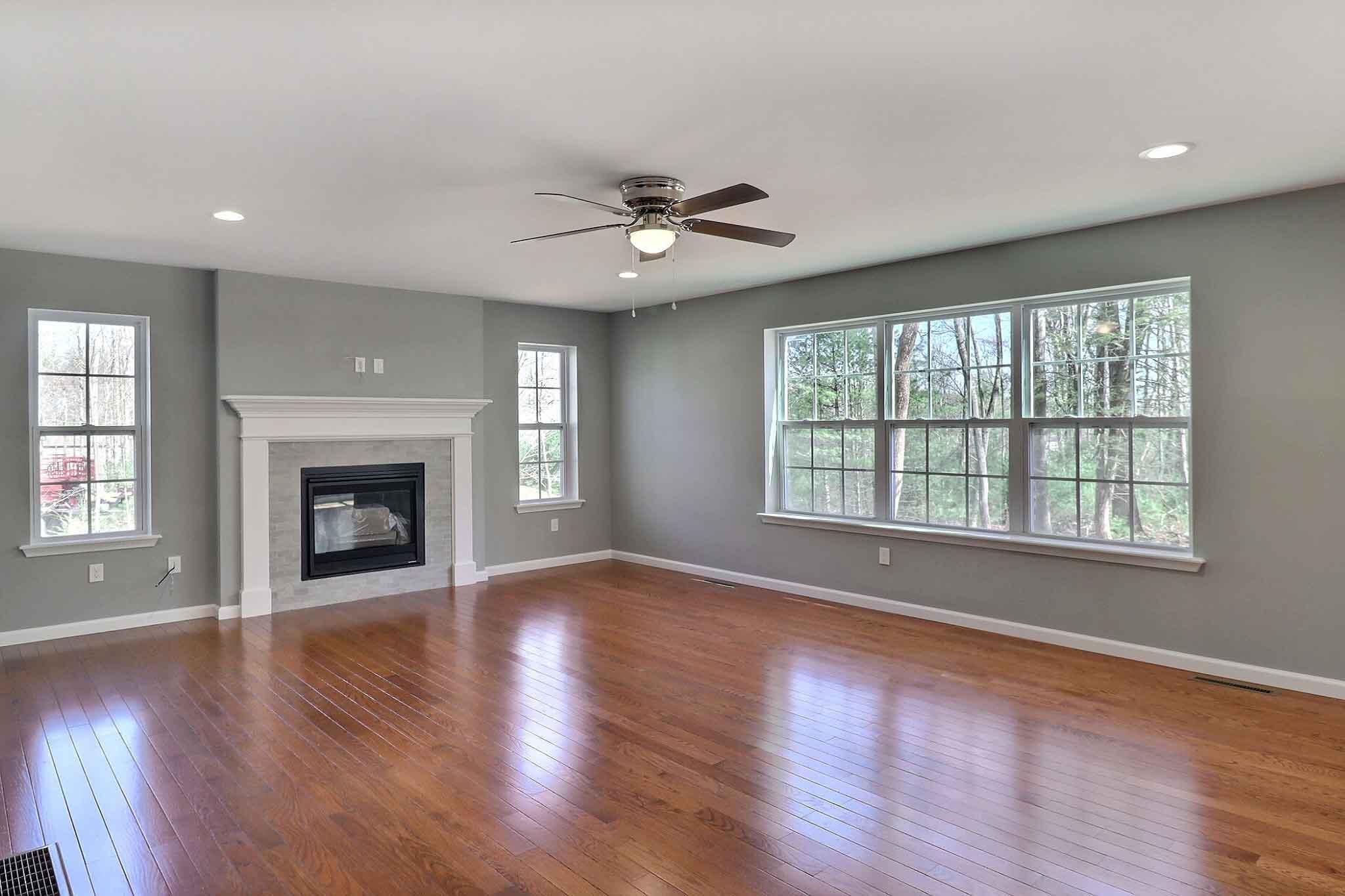 552 Long Mountain Road Effort, PA 18330 - Photo 14 of 47 an empty room with wooden floor fireplace and windows