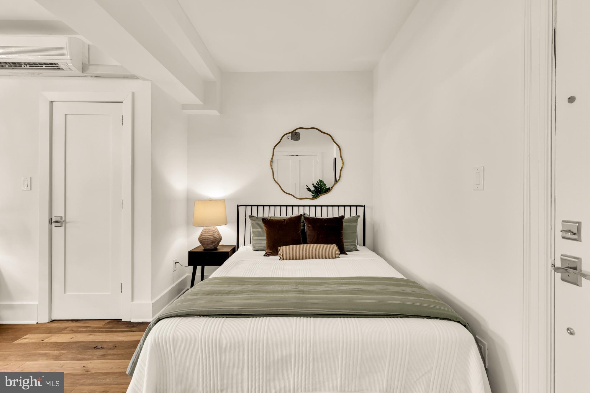1910 Kalorama Road Northwest, Unit 302 Washington, DC 20009 - Photo 7 of 28 a bedroom with a bed and a potted plant