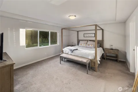 a bedroom with a bed chair and a window