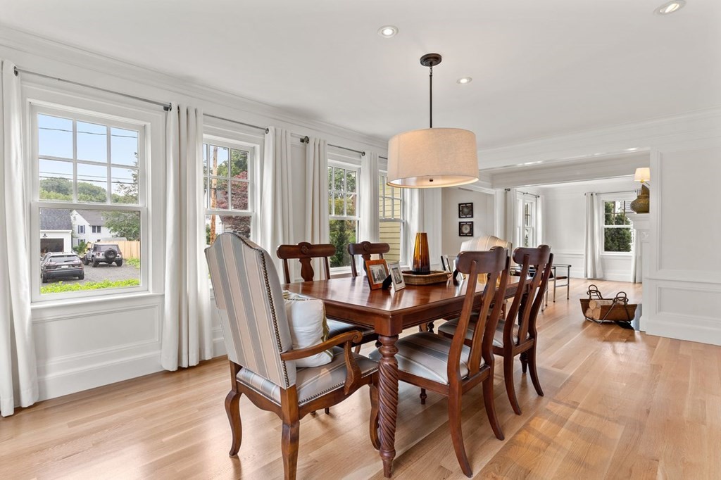22 Robert Road Marblehead, MA 01945 - Photo 15 of 41 a view of a dining room and livingroom with furniture wooden floor a chandelier