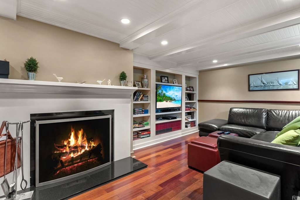 22 Robert Road Marblehead, MA 01945 - Photo 33 of 41 a living room with furniture a fireplace and a flat screen tv