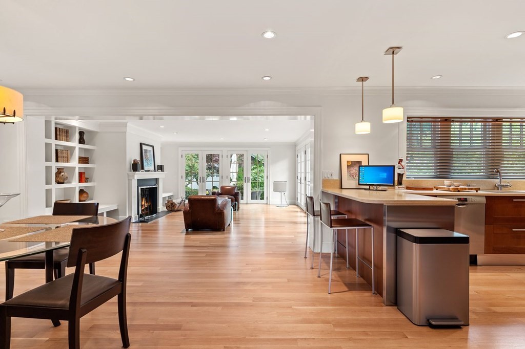 22 Robert Road Marblehead, MA 01945 - Photo 6 of 41 a kitchen with stainless steel appliances granite countertop a stove top oven a dining table and chairs with wooden floor