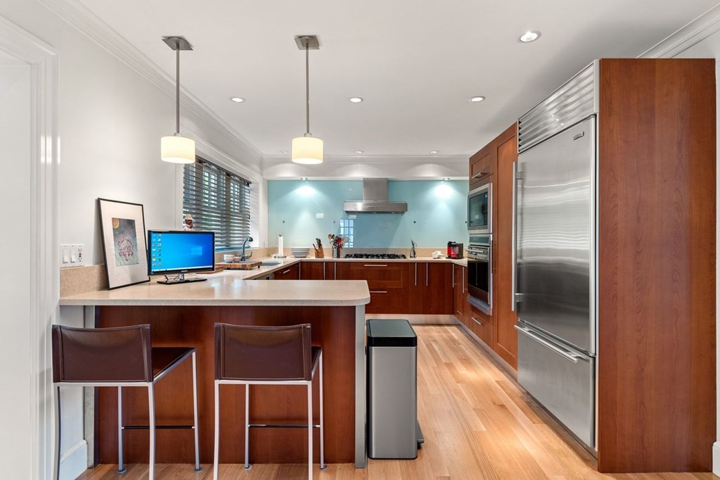 22 Robert Road Marblehead, MA 01945 - Photo 8 of 41 a kitchen with stainless steel appliances granite countertop a sink a stove and a refrigerator
