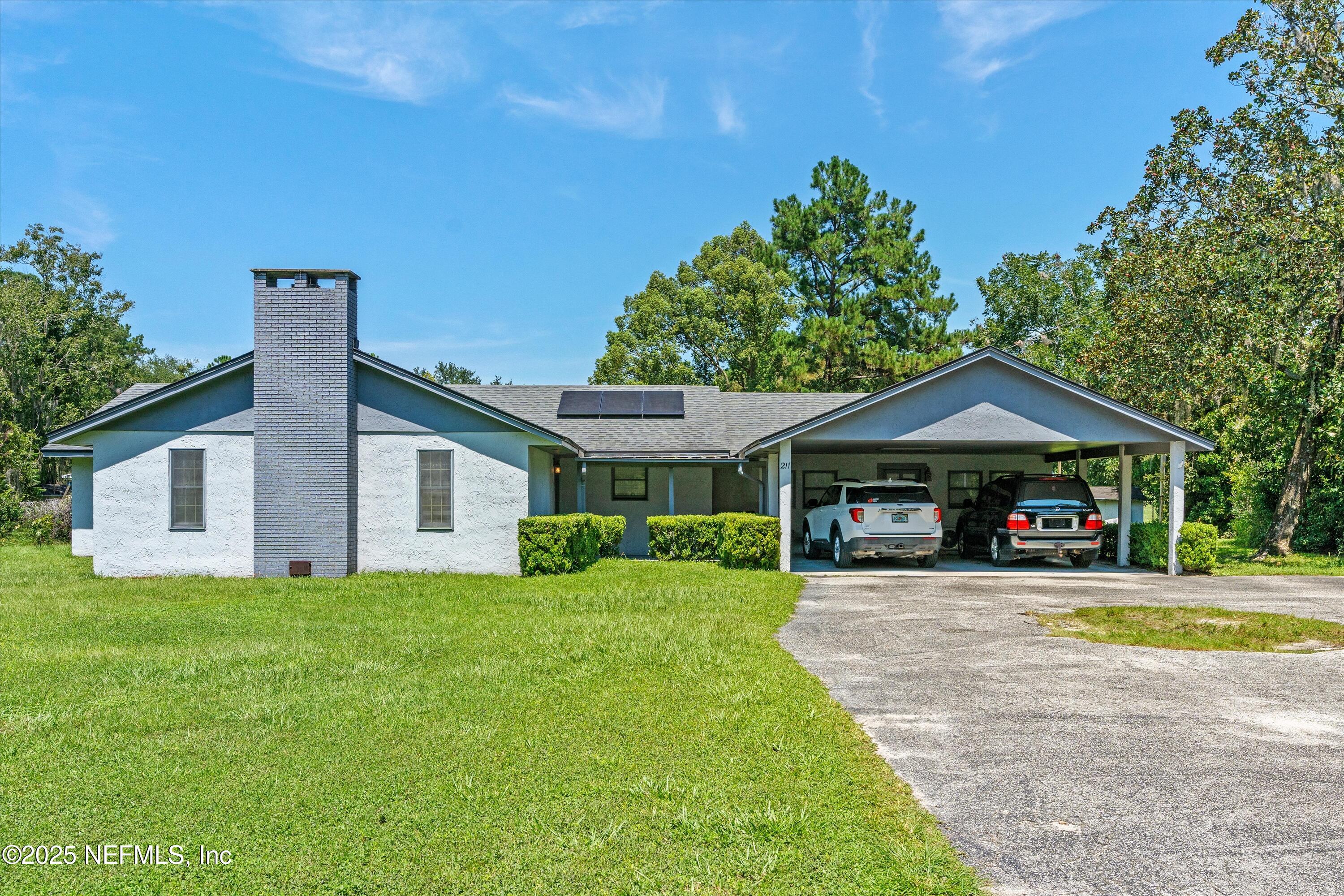 a view of a house with a yard and porch
