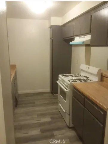 a view of staircase with wooden floor and white walls