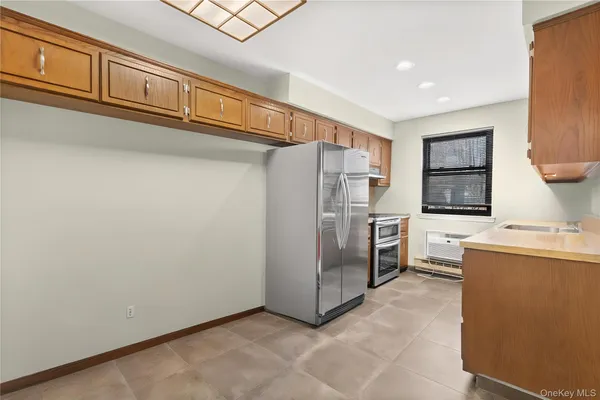 a kitchen with stainless steel appliances a refrigerator and a stove top oven