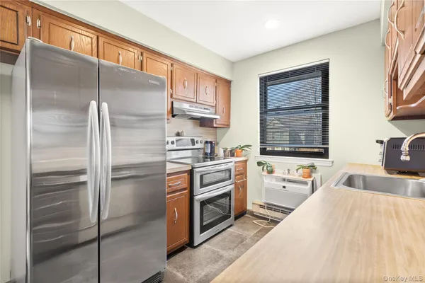 a kitchen with a refrigerator and a sink