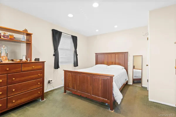 a bedroom with a bed and two windows