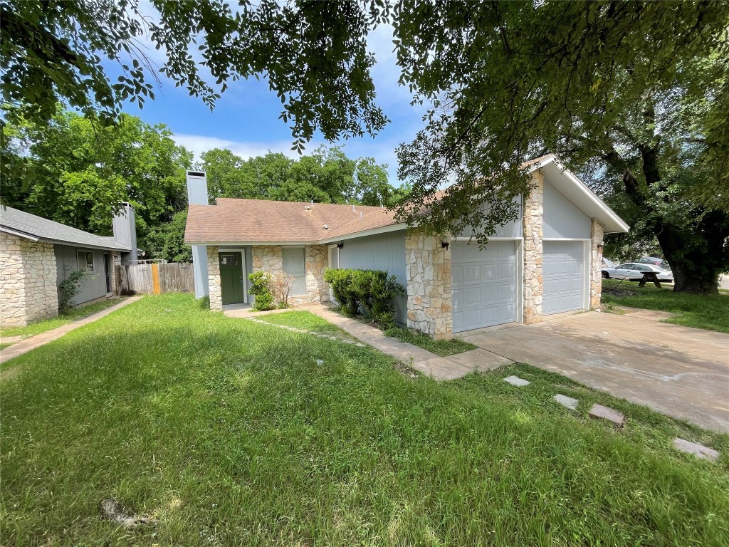 7506 St Amant Place Austin, TX 78749 - Photo 1 of 16 a front view of a house with a yard and garage