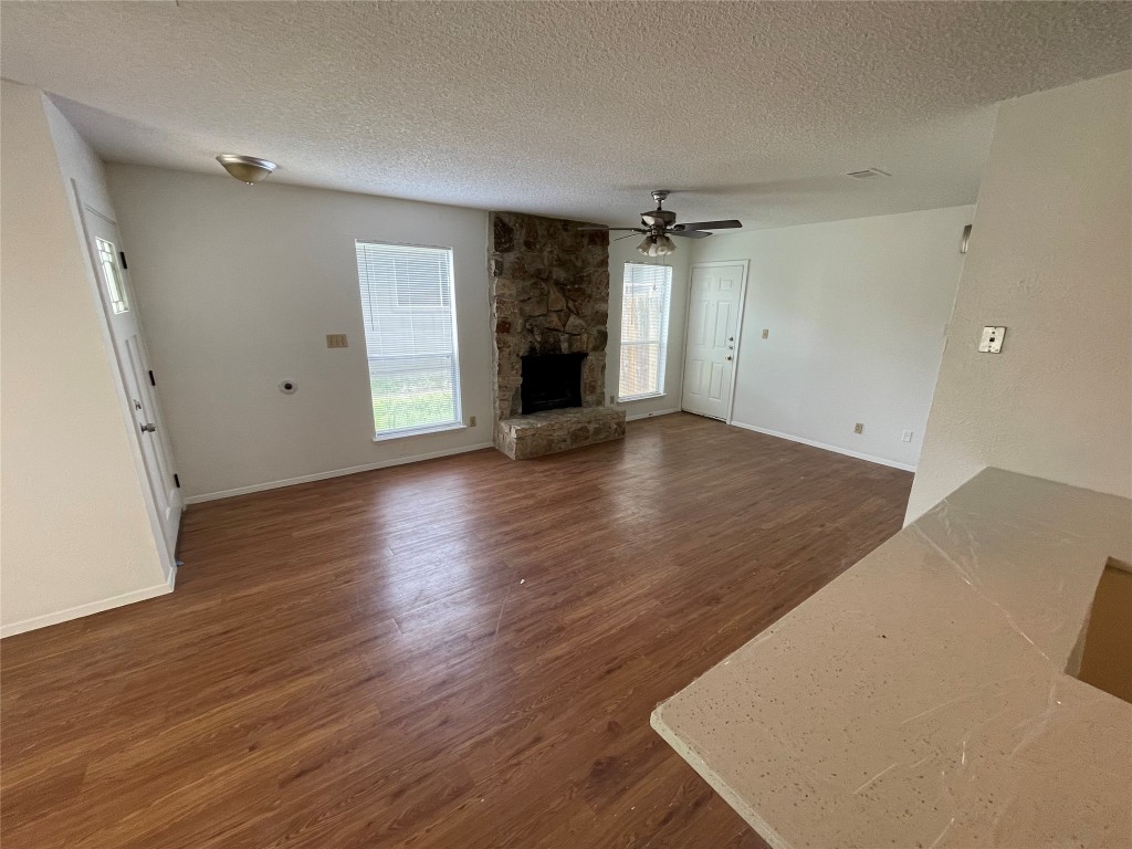 7506 St Amant Place Austin, TX 78749 - Photo 11 of 16 an empty room with wooden floor and windows
