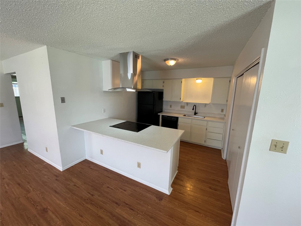 7506 St Amant Place Austin, TX 78749 - Photo 12 of 16 a kitchen with a refrigerator and a stove top oven