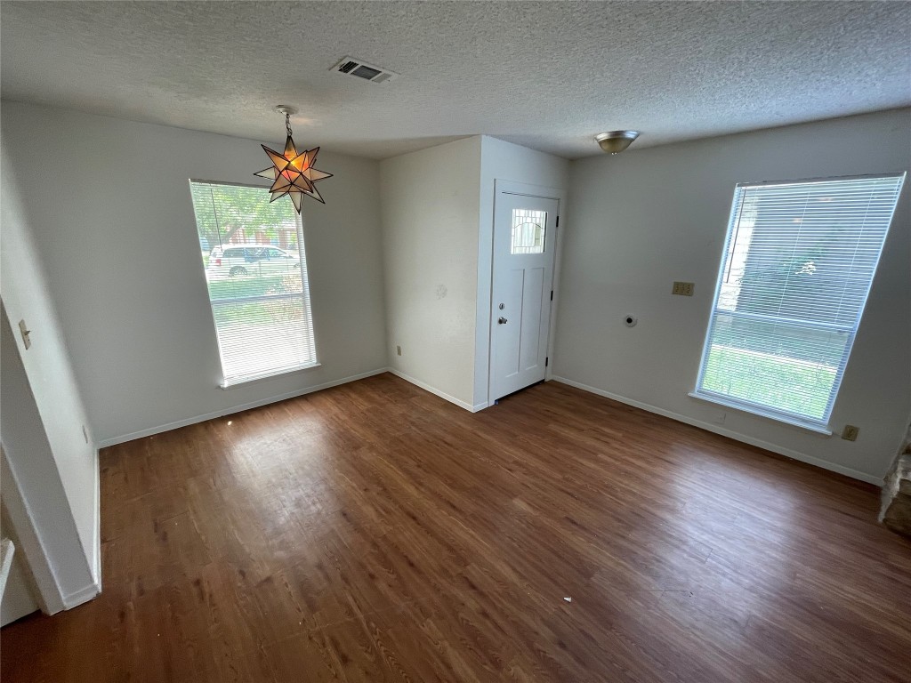 7506 St Amant Place Austin, TX 78749 - Photo 5 of 16 an empty room with wooden floor and windows