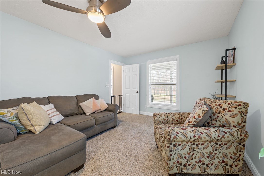 2425 McMackin Road Madison, OH 44057 - Photo 22 of 46 Carpeted living room featuring ceiling fan