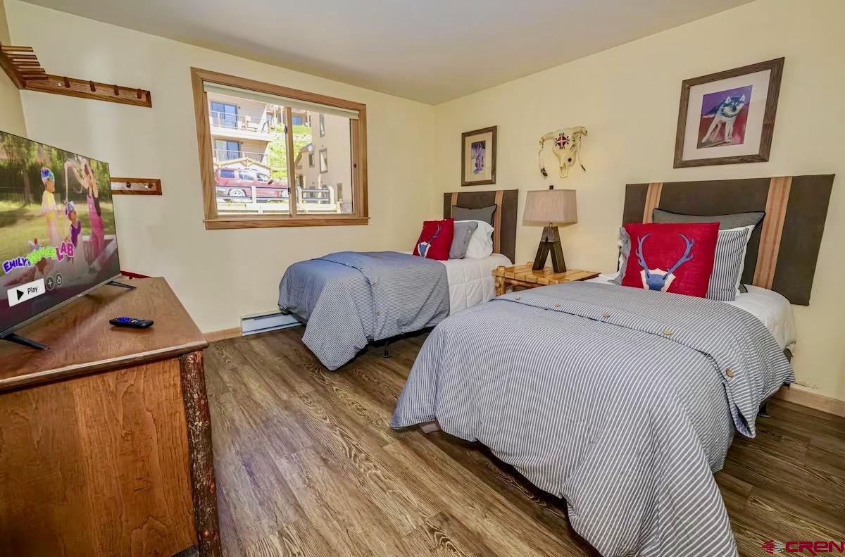20 Hunter Hill Road, Unit 202 Crested Butte, CO 81225 - Photo 12 of 25 a bedroom with two beds and a flat screen tv