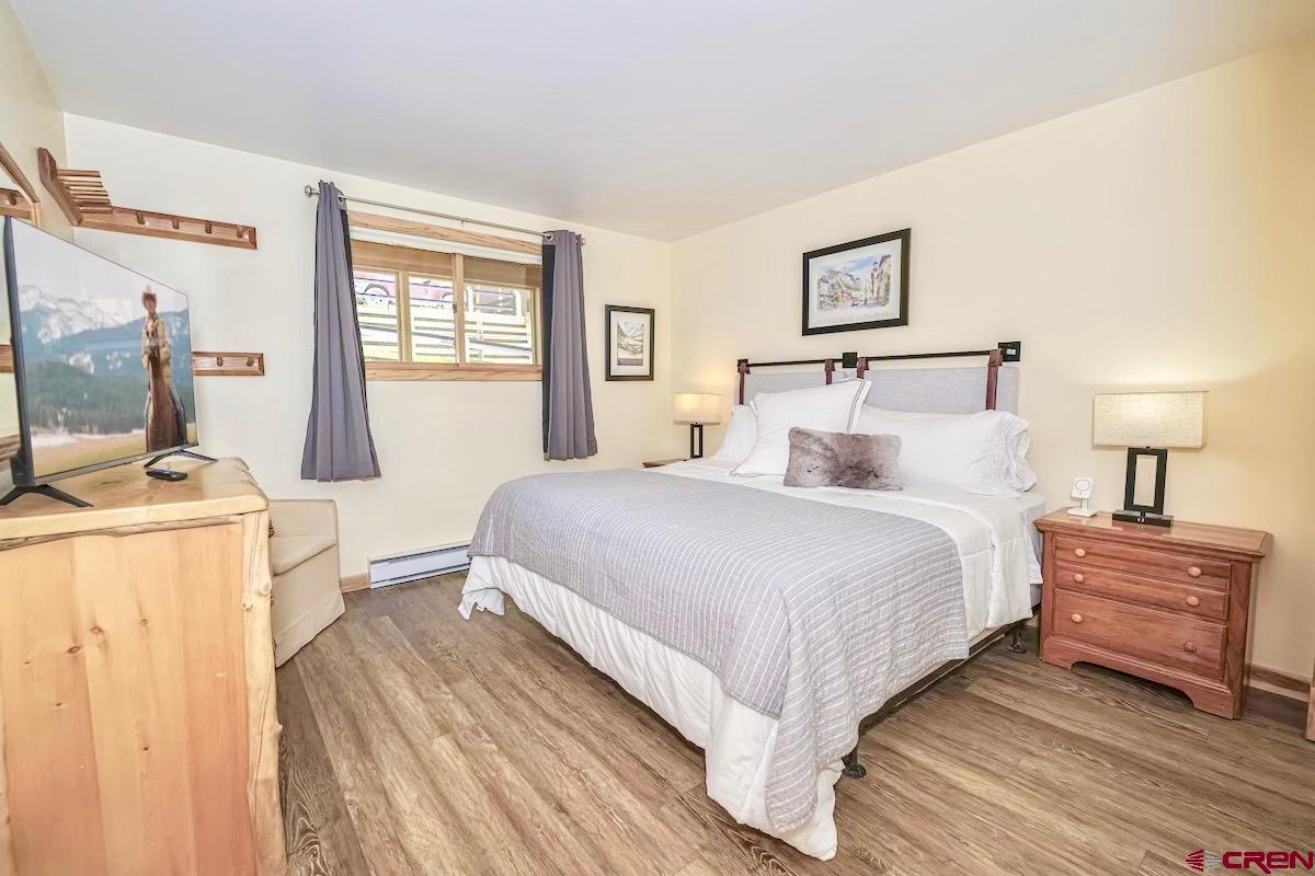 20 Hunter Hill Road, Unit 202 Crested Butte, CO 81225 - Photo 9 of 25 a bedroom with a large bed and a dresser