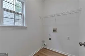 a view of a small space with wooden floor and a window