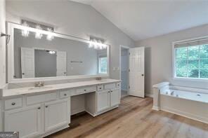 3686 Claredun Court Cumming, GA 30040 - Photo 15 of 29 a spacious bathroom with a granite countertop double vanity sink a mirror and a bathtub