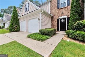 3686 Claredun Court Cumming, GA 30040 - Photo 2 of 29 a front view of a house with garden