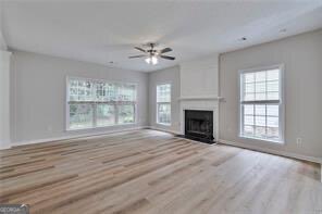 3686 Claredun Court Cumming, GA 30040 - Photo 3 of 29 wooden floor fireplace and windows in an empty room