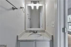 a bathroom with a granite countertop sink and a mirror