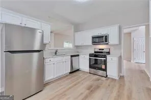a kitchen with a refrigerator stove and microwave