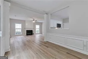 a view of empty room with wooden floor and fireplace
