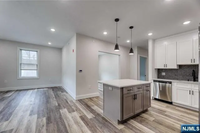 a kitchen with a stove a sink and a refrigerator