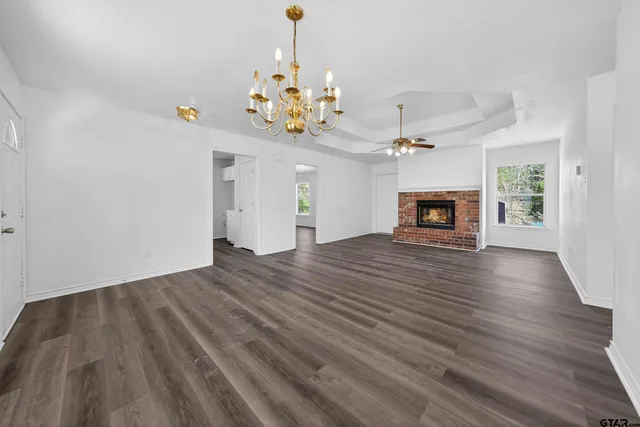 a view of an empty room fire place and a window