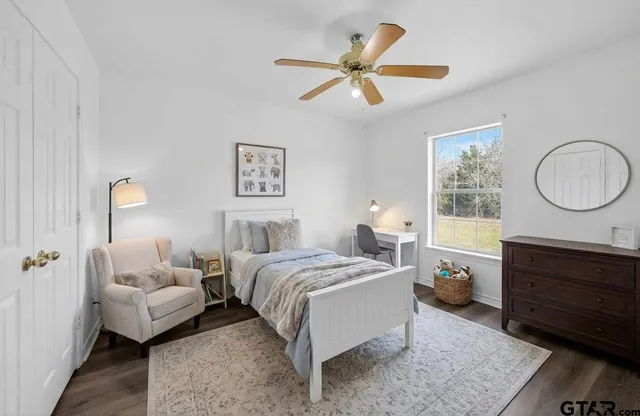 a bed room with a bed and a dresser