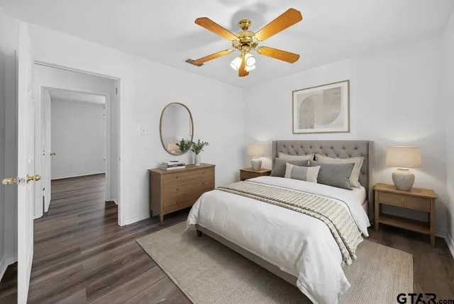 a bedroom with a bed and a chandelier