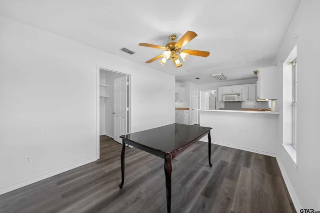 a view of a workspace with furniture and wooden floor