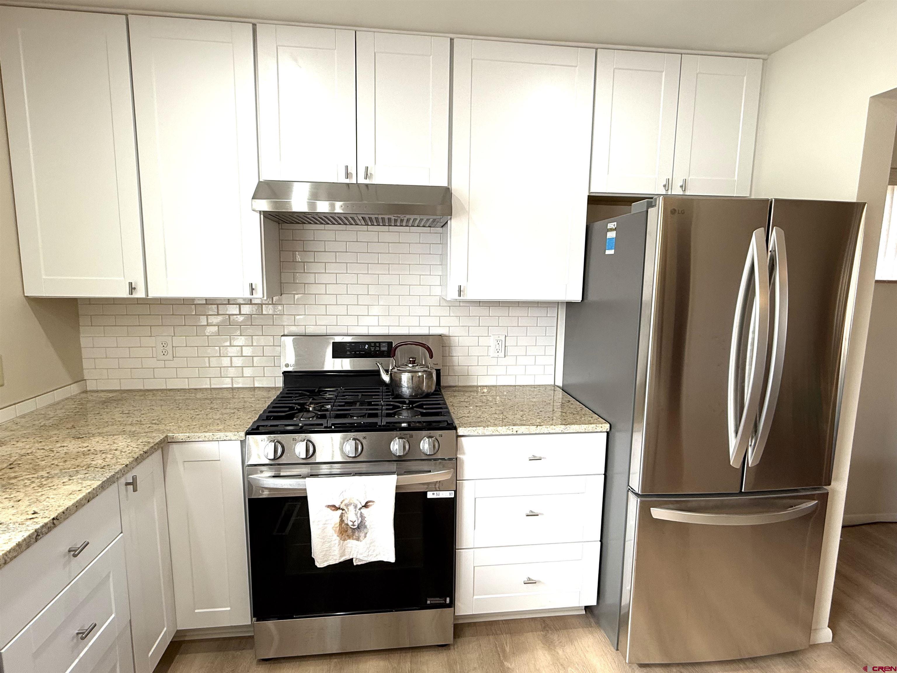 801 East 3rd Street Cortez, CO 81321 - Photo 11 of 22 a kitchen with cabinets appliances and a window