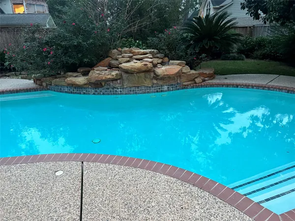 a view of a swimming pool with a yard