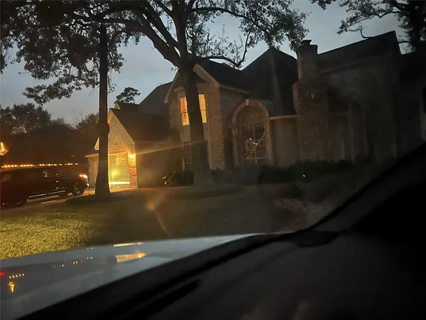 a view of back yard of the house and trees